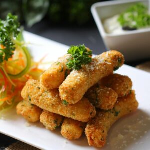 Delicious crispy mozzarella sticks served with fresh vegetable salad and creamy dipping sauce.